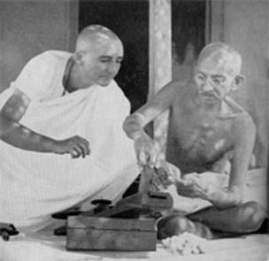 Miraben helping Gandhi repair his Charkha, Wardha, 1936 