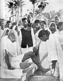 His feet being washed after the end of the daily march, Noakhali, December 1946